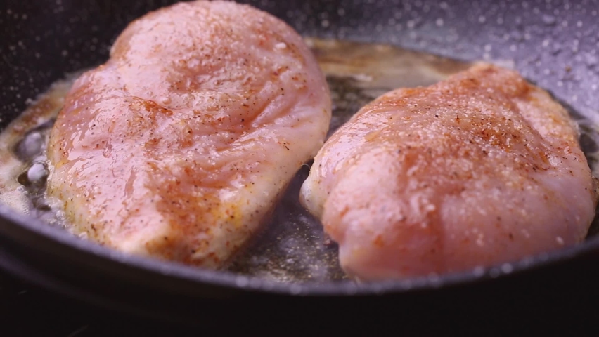 Chicken breast fillet fried lift with kitchen tongs. Royalty-Free Stock Footage #1093901211