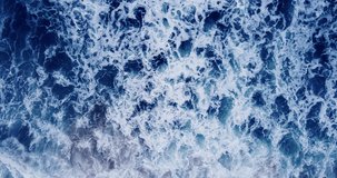 Drone view video of big power dark ocean waves with blue ocean. Aerial top-view footage of fabulous sea tide on a stormy day. Drone filming breaking surf with foam in Andaman sea. 4K 4096x2160p