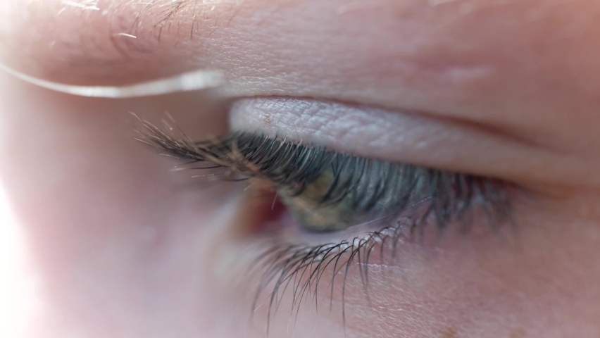 A close-up of a child's eye. A child looking into the far distance. Macro shot Royalty-Free Stock Footage #1093912045