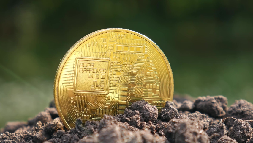 The concept of extraction and mining of cryptocurrency. Bitcoin dug up in the ground | Shutterstock HD Video #1093913397