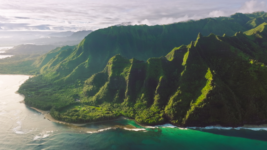Aerial pure nature environment of tropical island Kauai Hawaii. Cinematic nature aerial of world famous coastline. Outdoors adventure dream travel. Epic green jungle mountain coast nature background Royalty-Free Stock Footage #1093913549