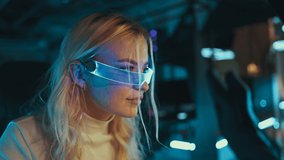 Blonde streamer playing shooter in neon 3D glasses. High quality 4k footage