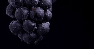 4K video of large grapes suspended and rotated.
Black background.
It's called 