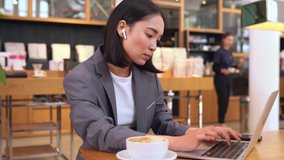 Busy smart young Asian professional business woman using laptop computer drinking coffee during lunch in cafe. Korean lady entrepreneur or manager remote distance working online watching webinars. - Powered by Shutterstock - Get 15% off with code: PIKWIZARD15