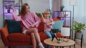 Blogger mother and child kid daughter sit at home living room enjoy listening music, dancing, recording video content for social media. Family enjoy selfie filming by internet network wifi connection - Powered by Shutterstock - Get 15% off with code: PIKWIZARD15