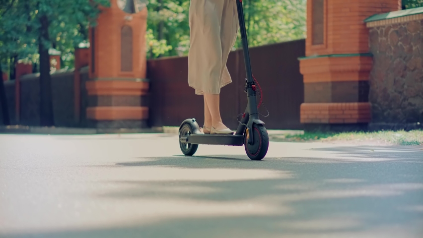 Fun Driving Electric Scooter. Relax On Kick Scooter. Sharing Ecology Transport.Woman Riding On Rent E-scooter. Urban Green Energy City ScooterTransport. Ecological Transportation Mobility In City Ride Royalty-Free Stock Footage #1093934149