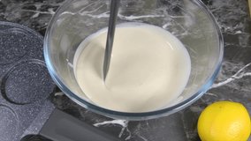 Slow motion video of cake mixture being stirred. kitchen environment. batter. stirring flour, pancakes 