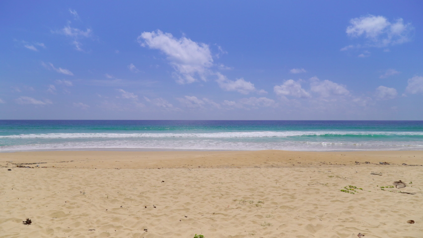 Beach sand blue ocean sea blue sky background video. Location Phuket beach sea, View of beach sea on sun light in the summer. At Karon Beach, Phuket, Thailand. 4K UHD, Video Clip ProRes 4:2:2 Royalty-Free Stock Footage #1093936189