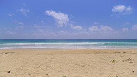 Beach sand blue ocean sea blue sky background video. Location Phuket beach sea, View of beach sea on sun light in the summer. At Karon Beach, Phuket, Thailand. 4K UHD, Video Clip ProRes 4:2:2