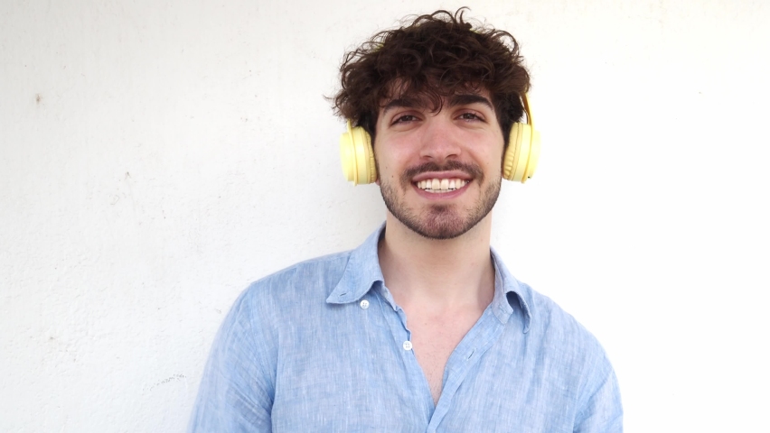 Italian man looking at camera laughing with headphones