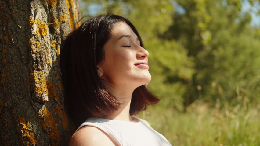 Happy middle eastern woman portrait. Young female student relaxing outdoor, cheerful female person sitting in park and smiling. Sunny summer day.  Royalty-Free Stock Footage #1093942567