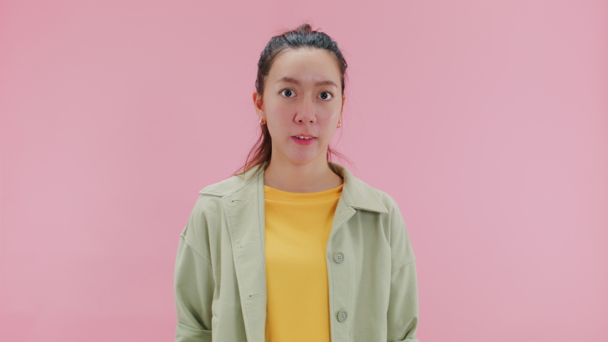SAY NO, Serious young asian woman doing warning or disapproving sign, don't do it, I don't need it or not allowed with finger shaking admonishing gesture looking at camera.Isolated on Pink Background Royalty-Free Stock Footage #1093943821