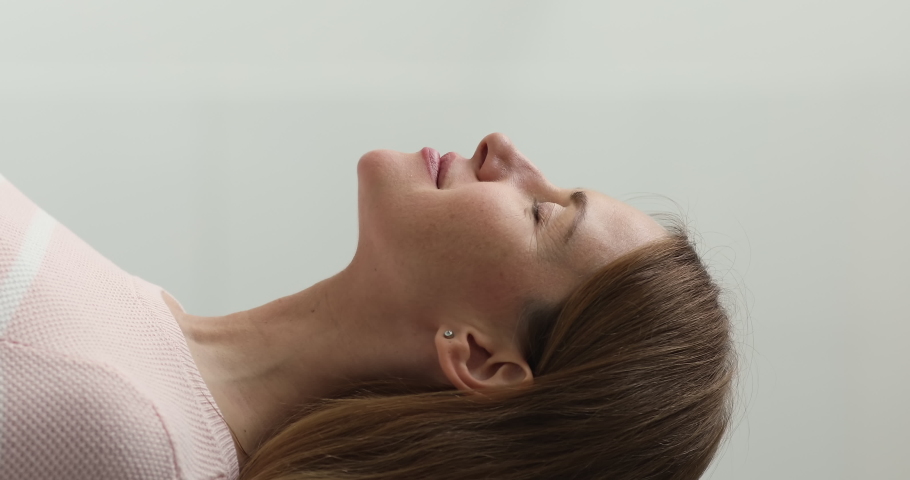 Close up vertical view woman enjoy fresh air inside with eyes closed, breathing room freshener, makes inhale exhale do meditation practice, relieving stress, pose alone, climate control indoor concept Royalty-Free Stock Footage #1093955439