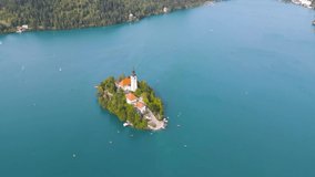 Lake Bled Slovenia Aerial 4k Drone Footage. Church on the Lake Bled from the air on a summer day. Bled Slovenia Aerial Video with Blue Lake waters.