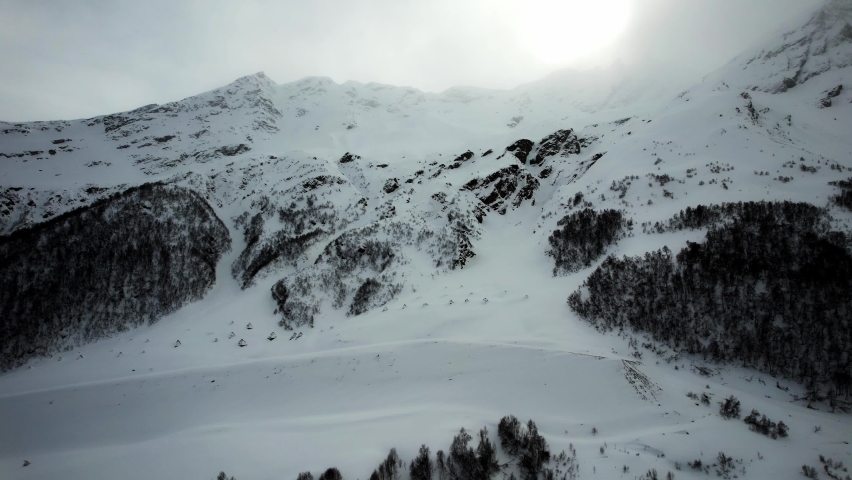 Mount Cheget. Anti-avalanche installations. The sun breaks through the clouds
