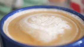 4K macro video of close-up rotating coffee espresso foam