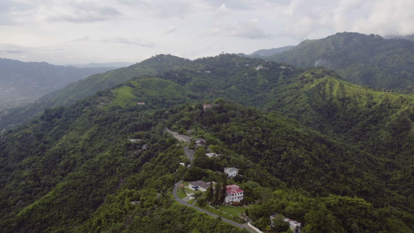Aerial view of Skyline Drive in Kingston Jamaica overlooking the city and the view of Kingston Town appears as the picture rotates. Royalty-Free Stock Footage #1093966175