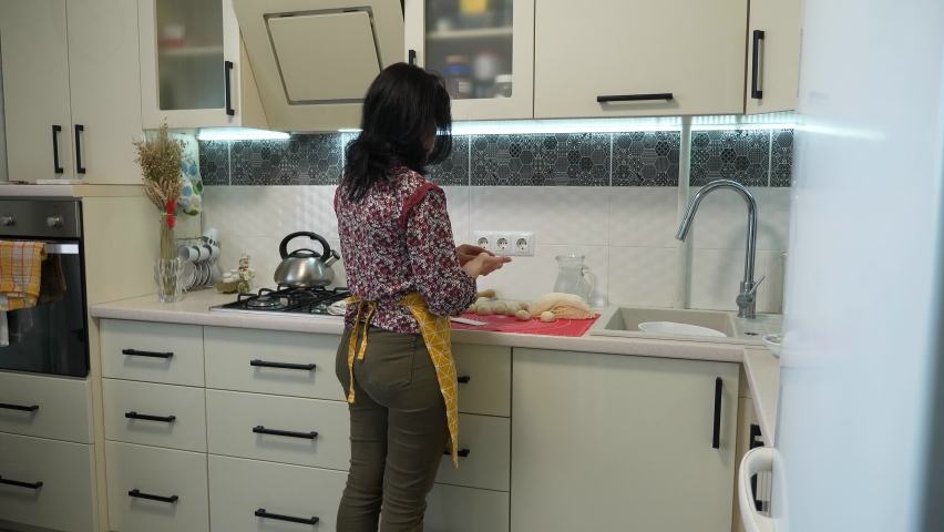 Young Female Housewife Cooking at Kitchen. Woman Making Buns Pies. 2x Slow motion 60fps 4K
