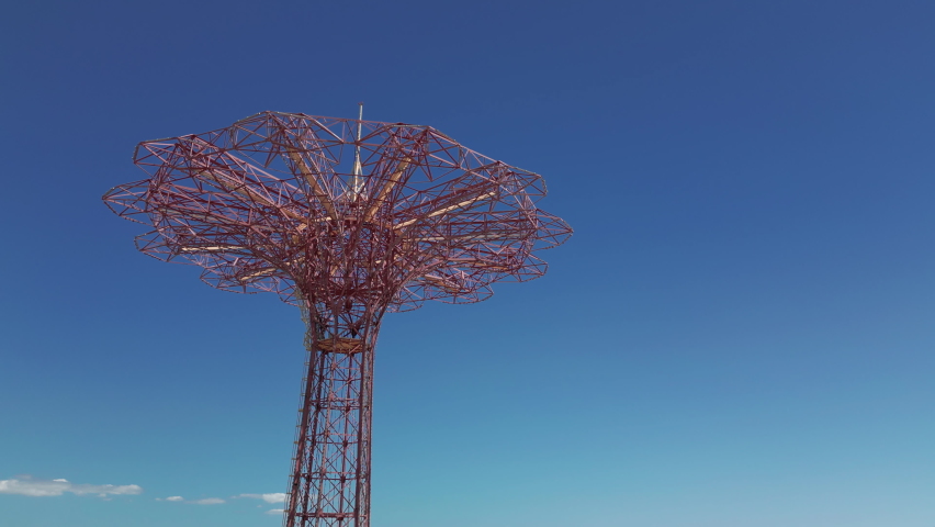 Rising and tilting down shot of iconic parachute jump tower of Coney Island