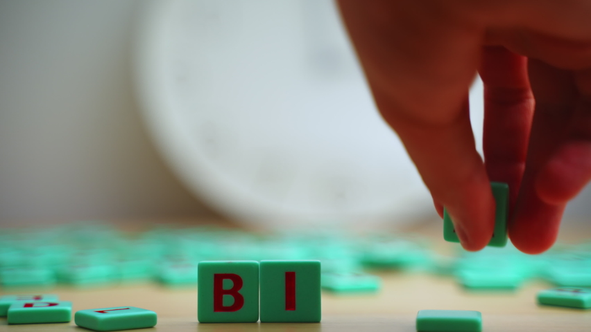 The word BIAS made of small colorful game board pieces with letters imprinted on them. Break the bias movement support. High quality 4k footage Royalty-Free Stock Footage #1093992125