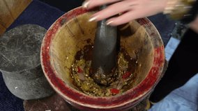 Young chili paste in a wooden mortar