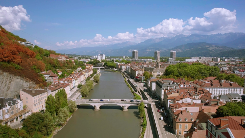 The drone aerial footage of the Isère river and Grenoble city, France. Grenoble is the prefecture and largest city of the Isère department in the Auvergne-Rhône-Alpes region.