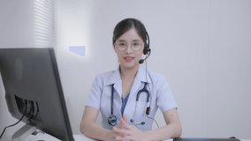 Telemedicine online,communication,technology concepts.Asian Female doctor wears headset to talking and give medication instructions to their patient remotely via telemedicine at the hospital.