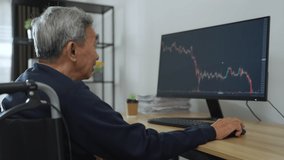 Senior man trader sitting wheelchair look to grap on monitor. He analyzes the technical charts on the screen for his trading plan. - Powered by Shutterstock - Get 15% off with code: PIKWIZARD15