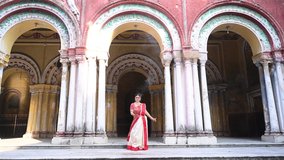Shot of a Bengali woman wearing red and white sari dancing with holding Dhunachi emitting incense during Durga puja festival in Kolkata, West Bengal. - Powered by Shutterstock - Get 15% off with code: PIKWIZARD15