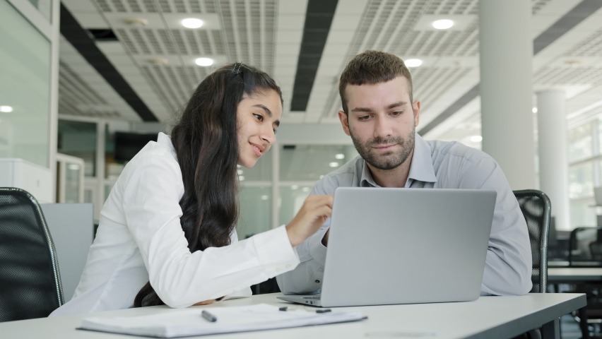 Young recruit woman presenting project on laptop to mentor professional female manager training new male worker explains online services to client on monitor discussing teamwork at business meeting Royalty-Free Stock Footage #1094015379