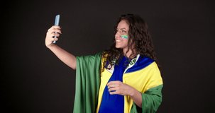 Soccer fan, Brazilian woman, Chatting on cell phone via video call. in a world championship game.