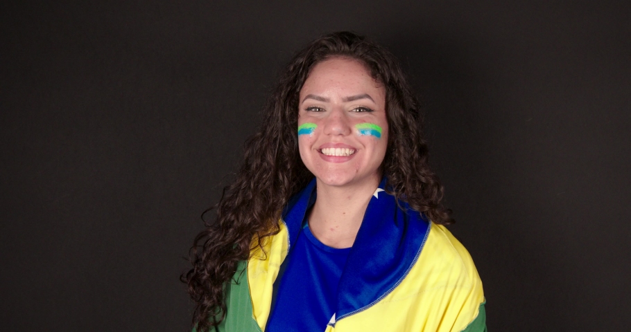 Soccer fan, Brazilian woman, close-up scene, smiling looking at camera, at world championship game. | Shutterstock HD Video #1094018495