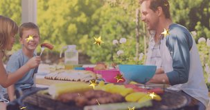 Animation of stars over smiling caucasian family having bbq and talking. bbq day and celebration concept digitally generated video.