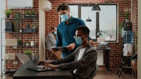 Diverse team of colleagues working on business collaboration to create research project with data charts during covid 19 pandemic. Teamwork partnership with coworkers, using laptop. - Powered by Shutterstock - Get 15% off with code: PIKWIZARD15
