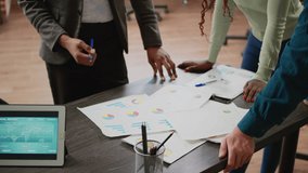 Business people analyzing charts information on documents, using files and papers to create report analysis. Colleagues working with diagrams and graphs to plan research. Close up. - Powered by Shutterstock - Get 15% off with code: PIKWIZARD15