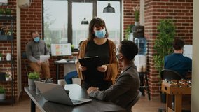 Diverse team of colleagues working on company data in office during covid 19 pandemic. Using laptop to plan business charts presentation with documents, teamwork collaboration. - Powered by Shutterstock - Get 15% off with code: PIKWIZARD15