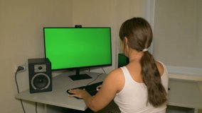 Girl is typing text on the keyboard. Chromakey on computer screen.

Video with a chroma key on the screen to insert any video or image.