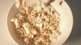 Popcorn Is Poured Into A Bowl - Powered by Shutterstock - Get 15% off with code: PIKWIZARD15