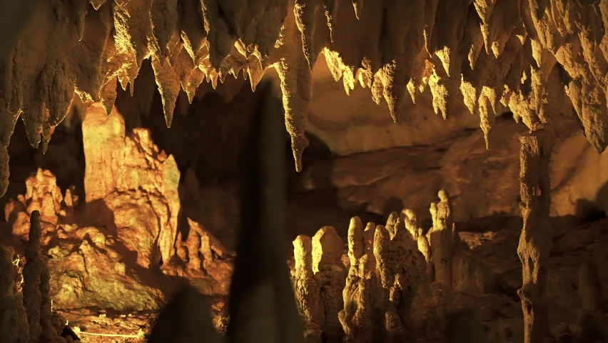 Stalactites and stalagmites formations inside the cave. Beauty in nature concept. Cinematic shot Royalty-Free Stock Footage #1094038379
