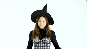 Halloween theme asian woman in black dress and witch hat posing smiling moving on white background video 4K. 