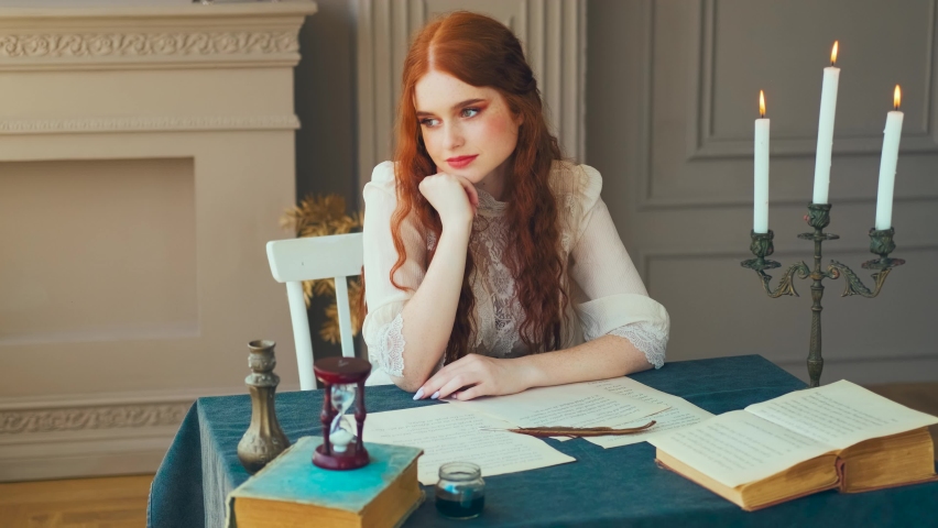 Medieval red-haired woman queen writer holds pen feather quill in hands, romantic face, red hair. Girl sits at desk writes love letter on sheet paper. Vintage dress old books. student studying in room Royalty-Free Stock Footage #1094039517