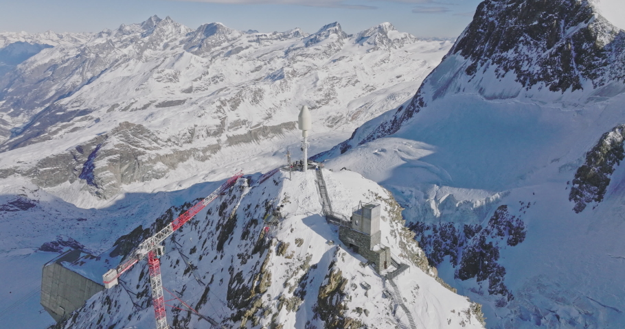 Aerial drone fly around Matterhorn Glacier Paradise during winter in Switzerland. Majestic mountain peaks iconic famous zermatt travel ski resort in the alps. Wonderful inspiring nature landscape.