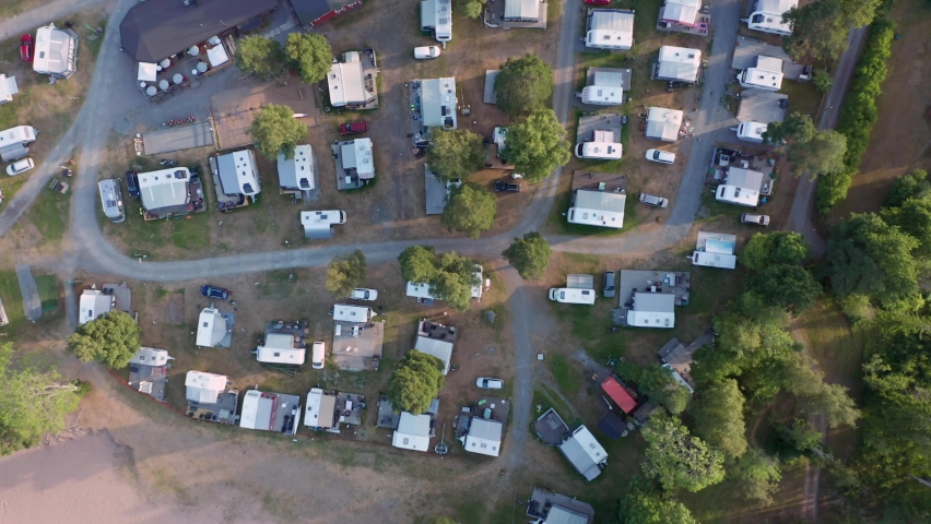 Campground overhead top down. Motorhome caravan mobile home in nature between forest at beach in sweden