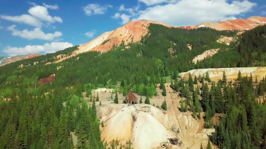 4K drone aerial shot of ghost town mining structure Yankee Girl mine on Red Mountain Pass between Ouray and Silverton, Colorado, San Juan mountains, United States of America