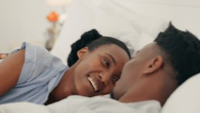 Happy black couple embrace and bonding in bed, touching, flirting and loving. Smiling African American husband and wife being romantic, enjoying their time together indoors, bedroom fun affection - Powered by Shutterstock - Get 15% off with code: PIKWIZARD15