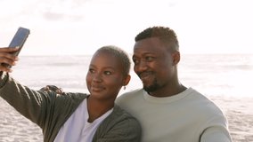 Happy, selfie and couple love at beach with 5g network phone photography of sunset for social media, internet or website app. Smile, black woman and man with tech while travel, ocean and picnic. - Powered by Shutterstock - Get 15% off with code: PIKWIZARD15