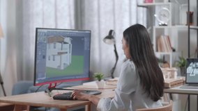 Asian Woman Engineer Celebrating While Designing House On A Desktop At Home. Cyber Games House Design And Decoration
