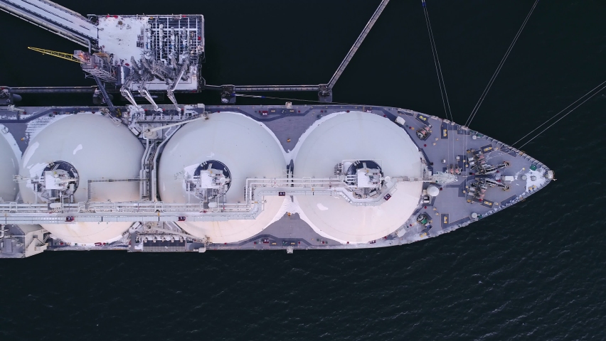 Aerial of Liquified Natural Gas LNG carrier moored to a small gas terminal. Fuel crisis. Sanctions