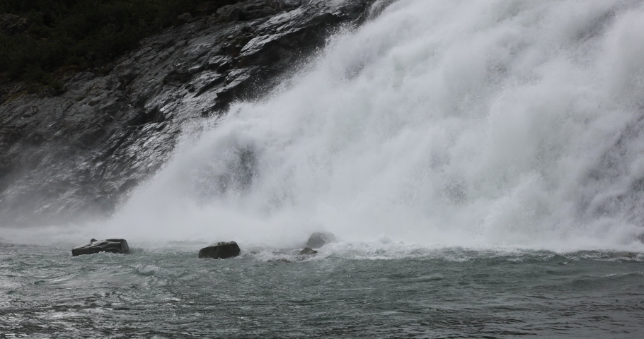 Nugget Falls waterfall Mendenhall Glacier close. Waterfall from glacier. Cruise ship destination Juneau Alaska. Climate change global warming result is rapidly retreating, shrinking, and melting. Royalty-Free Stock Footage #1094077895