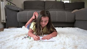 Cute young girl drawing or painting with colored pencil. Children education, back to school, child study at home concept. High quality 4k footage